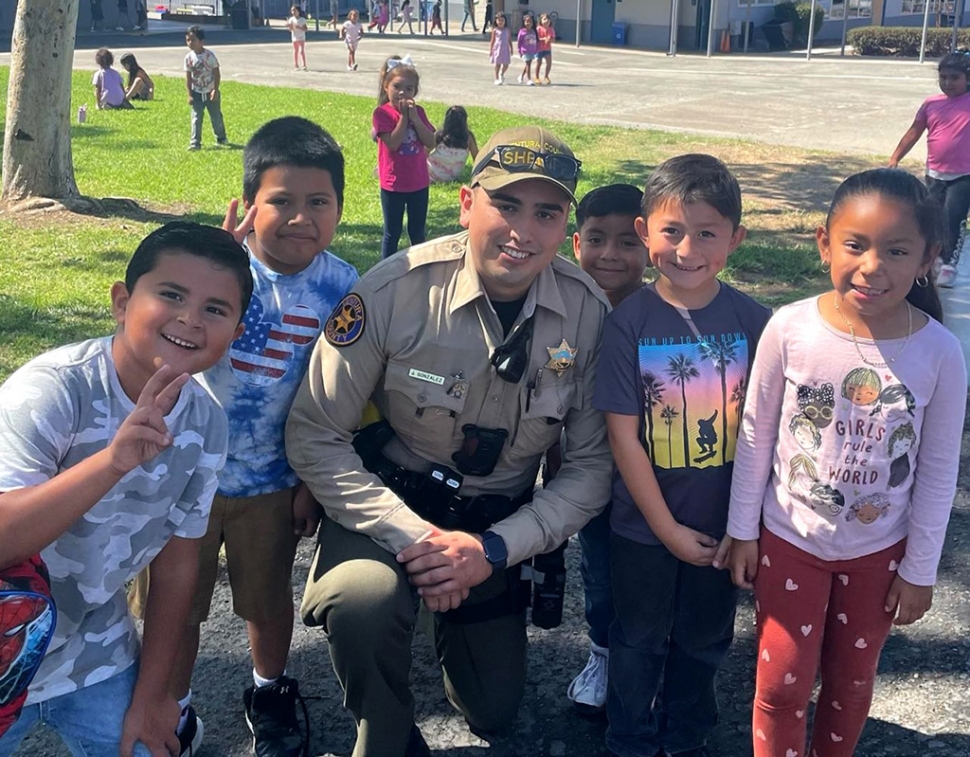 Deputy Gonzalez at San Cayetano Elementary answering student questions and interacting with them during recess, as part of Fillmore Unified School District’s Adopt-A-Cop program in partnership with the Ventura County Sheriff’s Department. Photo courtesy San Cayetano Elementary blog.