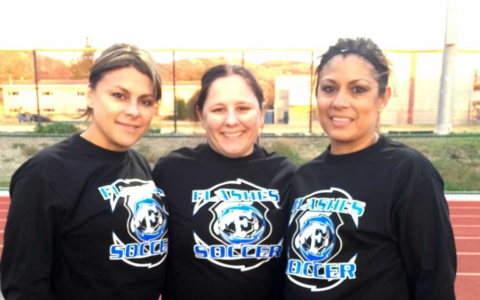 Liz Lomeli, Class of 90, Trina Tafoya, Class of 93, and Jenny Andrade, Class of 92 share a hug before the start of the game. The Fillmore High School girls would like to thank all the alumni players who came out to support the program.