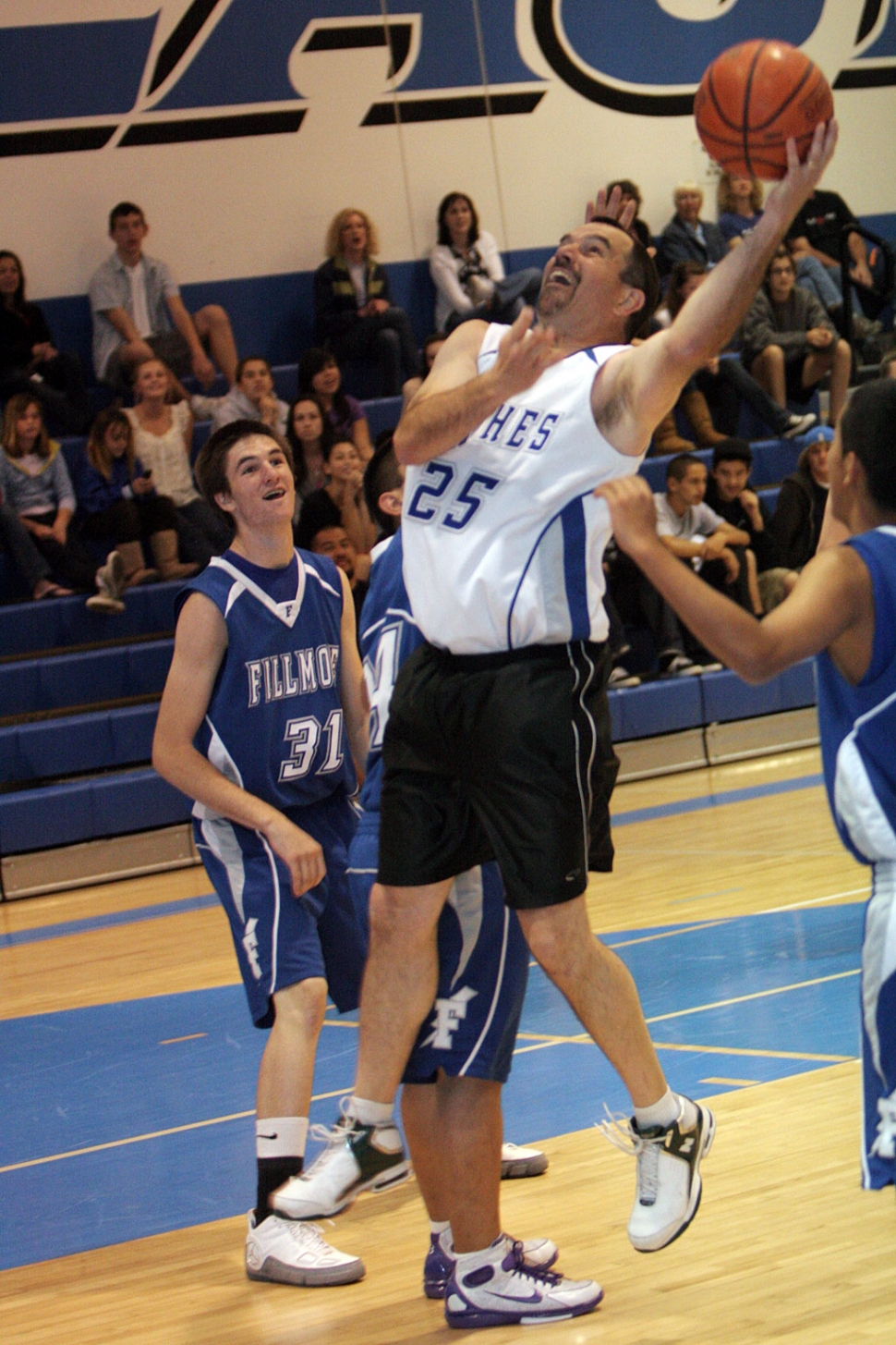 F.H.S. Principal John WIlber goes in for 2 points during the alumni basketball game this past Saturday. Varsity went on to win.