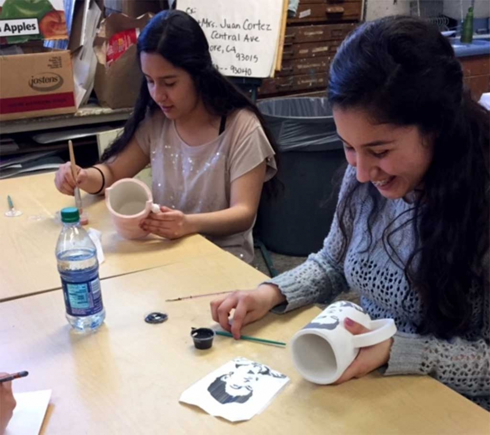 Fatima and Daniela Castillo working on glazing their mugs in Ceramics class in preparation for the annual arts show.