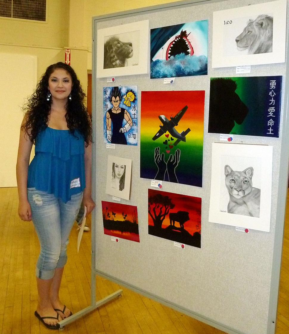 Brittany Gonzalez, a Senior at FHS, stands along side her amazing display of art work at the FHS Art Show held Tuesday, April 12, 2011.