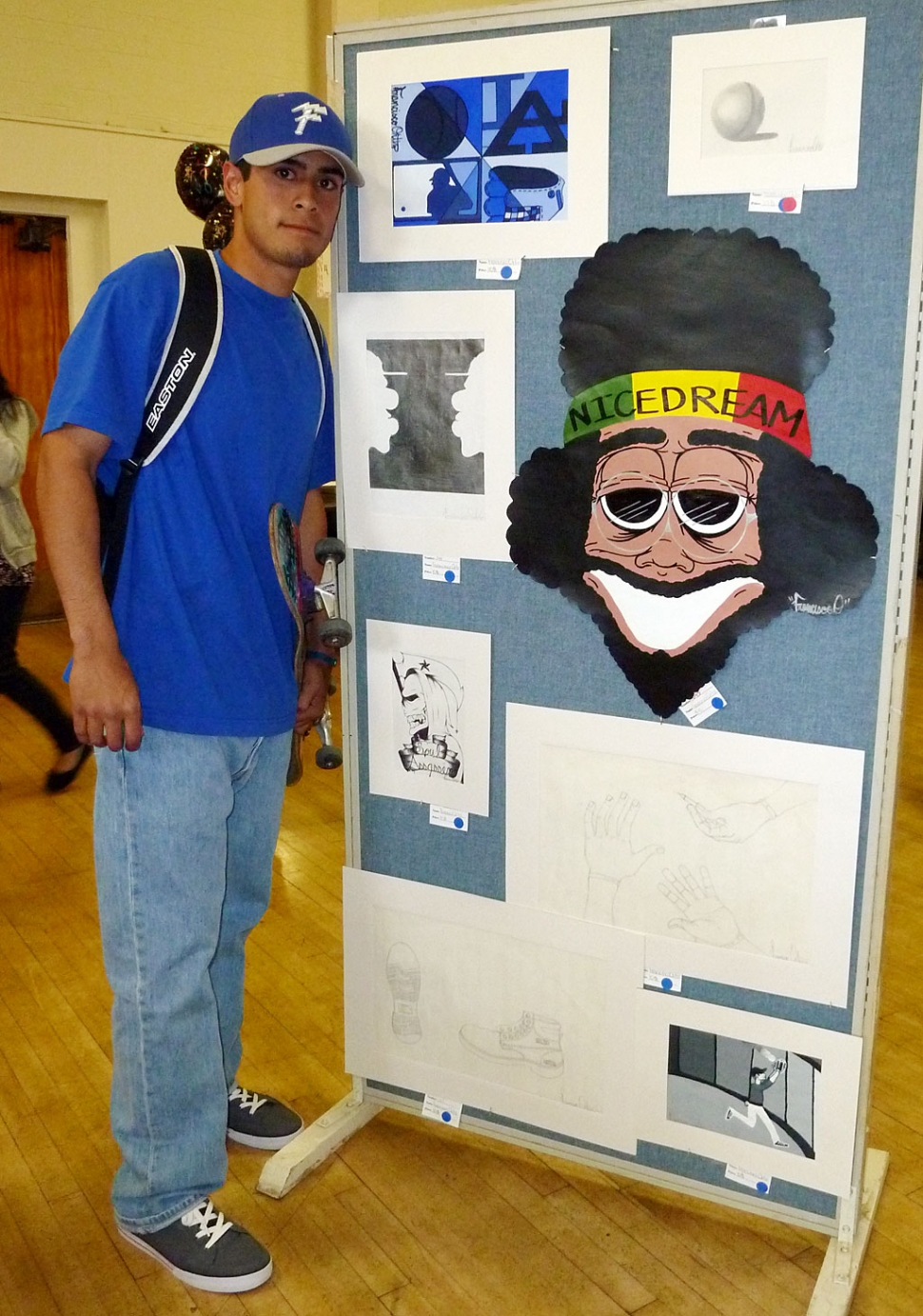 Francisco Ortiz, a Junior at FHS, is very proud of his awesome art work on display at the Art Show.