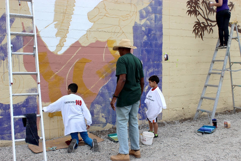 (left) Cuban sculptor and painter Pedro Pulido mentoring kids while painting the “Havana to Ventura” Mural