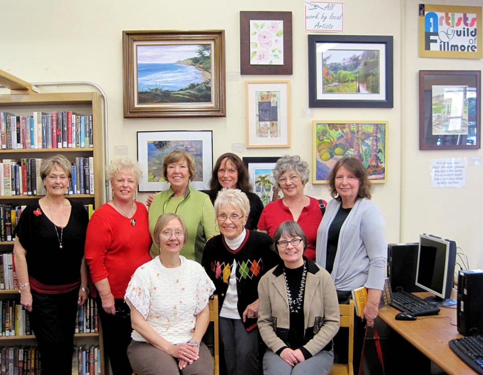 Back row: Artists Guild of Fillmore members Wana Klasen, Luanne Perez, Karen Browdy, Lois Freeman-Fox, Joanne King, Virginia Neuman, and Front row first two: Jan Faulkner and Judy Dressler. They have just shown our Fillmore Library Supervisor, Cathy Krushell, front row far right, their new group of paintings.