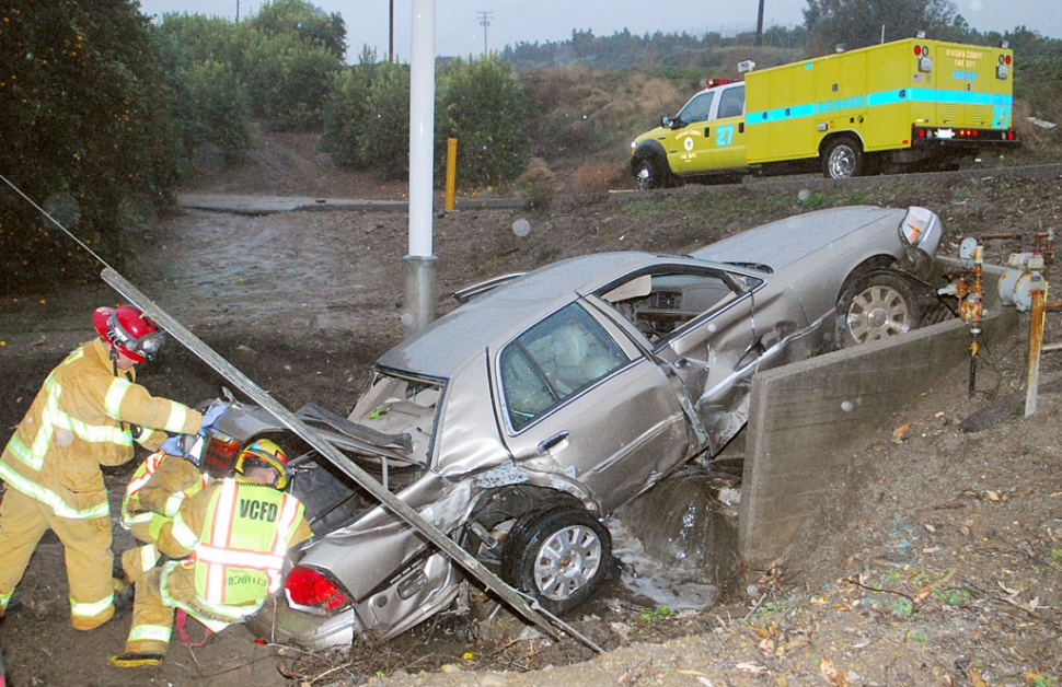 Weather related accidents pile up. Sunday, at approximately 5 p.m., the driver of this car was eastbound when he lost control of his vehicle and dropped down a 25-foot embankment near Atmore Road off Highway 126. The car then clipped several lemon trees, destroyed a steel pipe gate, struck a paved work road, and proceeded down another 15-foot embankment, crashing into a creek. The car then spun around 90 degrees, narrowly missing a power pole, ending up wedged into a concrete culvert, inches away from a high-pressure natural gas pipeline. The driver suffered a few minor scratches to his hand. No passengers were involved.