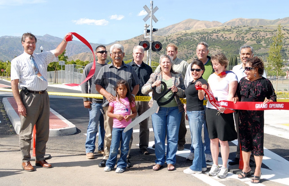 The ribbon cutting for the B Street Railroad Crossing Project took place on Wednesday, May 12th at Old Telegraph and B Street. Pictured (l-r, front row) are Director of Public Works Bert Rapp, Max Pina (with granddaughter), Mayor Patti Walker, Councilmember Laurie Hernandez, and City Manager Yvonne Quiring. The Gazette was unable to ID everyone at press time. The project took about 10 years at a cost of $2.2 million, and was built through the worst fl ooding area in the city, without worsening anyone’s fl ooding problem, according to Rapp. Grants were secured from Safe Routes to School $185,000; CDBG $165,000; and Prop. 1B $266,000, totaling $611,000. The remaining funding came for the Fillmore Redevelopment Agency. The city had to obtain permits for a new railroad crossing form the California Public Utilities Commission. The new street will provide traffic relief for the A Street school crush and provide improved emergency response to north Fillmore.