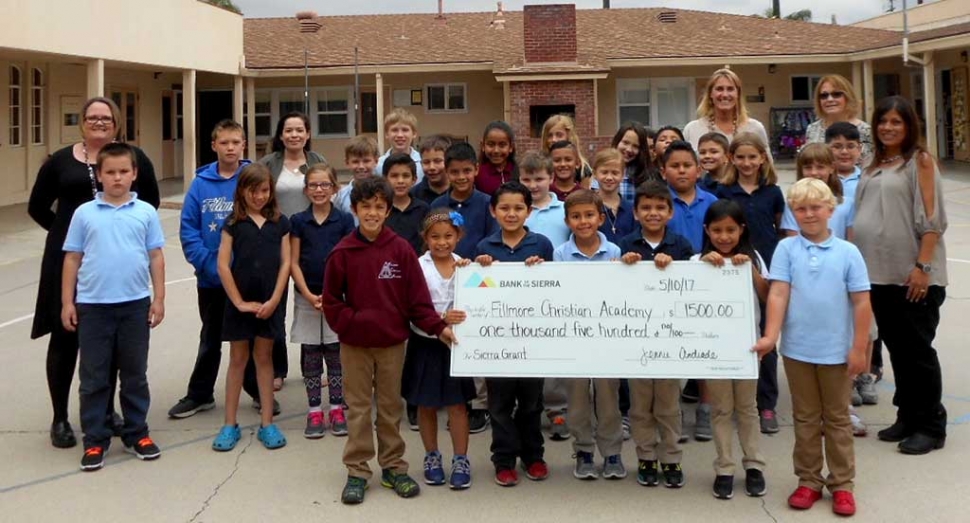 Fillmore Christian Academy staff and students wish to thank Bank of the Sierra for their generous donation of $1,500 to the school. The funds will be used to purchase new classroom supplies that are needed for the upcoming school year. Pictured is Jennie Andrade, Operations Manager and Alicia Hicks, Financial Services, from Bank of the Sierra presenting the check to the Fillmore Christian Academy staff and students. The Academy appreciates the generosity of Bank of the Sierra and their commitment to supporting the children in the community.