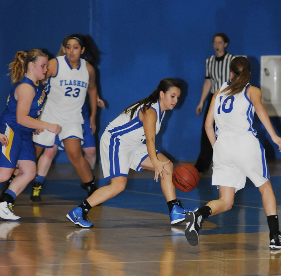 Kayla Grove #4 dribbles down court . Also pictured Mary Ortiz #23 and Ana Morino #10.