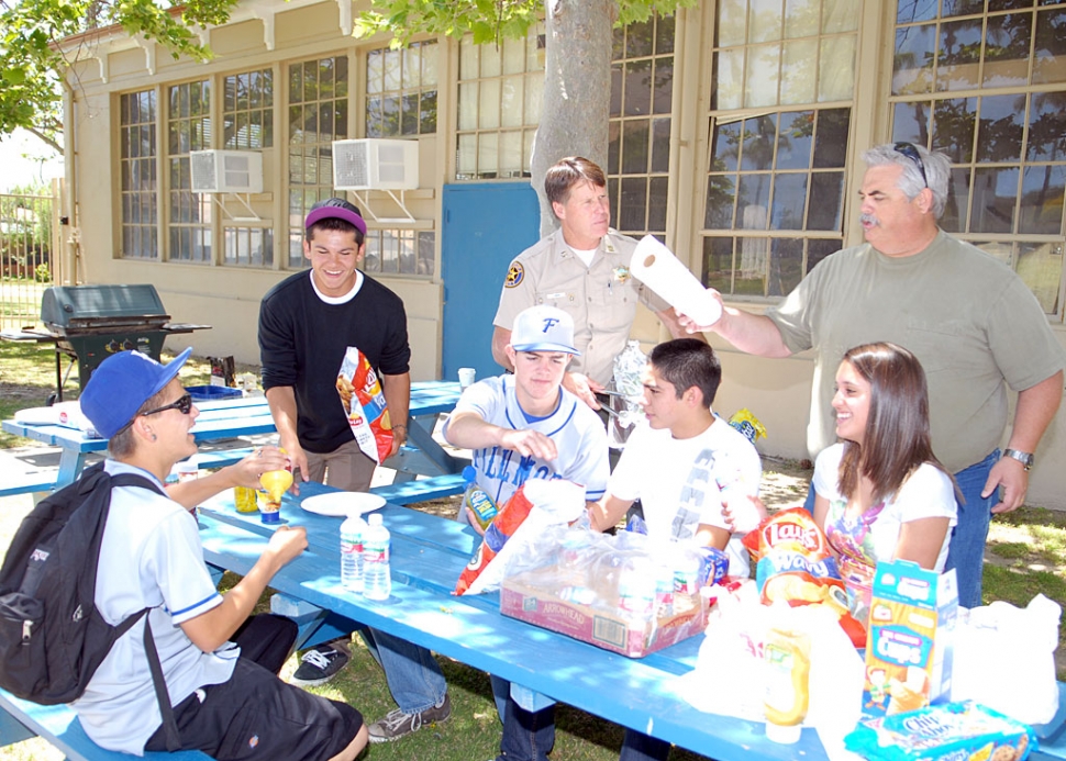 Police Chief Tim Hagel and Councilman Steve Conaway barbecued lunch for several high school kids last week.
