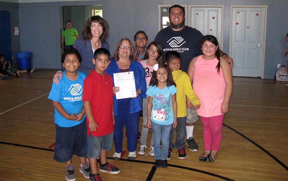 Leslie Klinchuch, Project Manager for Chevron Environmental Management Company present a check for $5000 to the Boys & Girls Club of Santa Clara Valley. Pictured with some of the Club Members are CEO Jan Marholin and Site Director Buddy Escoto. the $5000 will be used for STEM Programs at the Club including the championship robotics team The Stompers. Thank you Chevron!