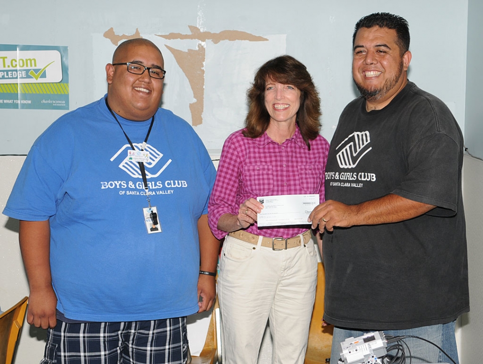 Leslie Klinchuch Project Manager for Chevron presents a check to Lorenzo and Buddy from the Boys & Girls Club. The $5000 donation is to used towards the Club's STEM Programs which include Robotics, Science, and Math activities. The Boys & Girls Club of Santa Clara Valley appreciates the program support from Chevron.