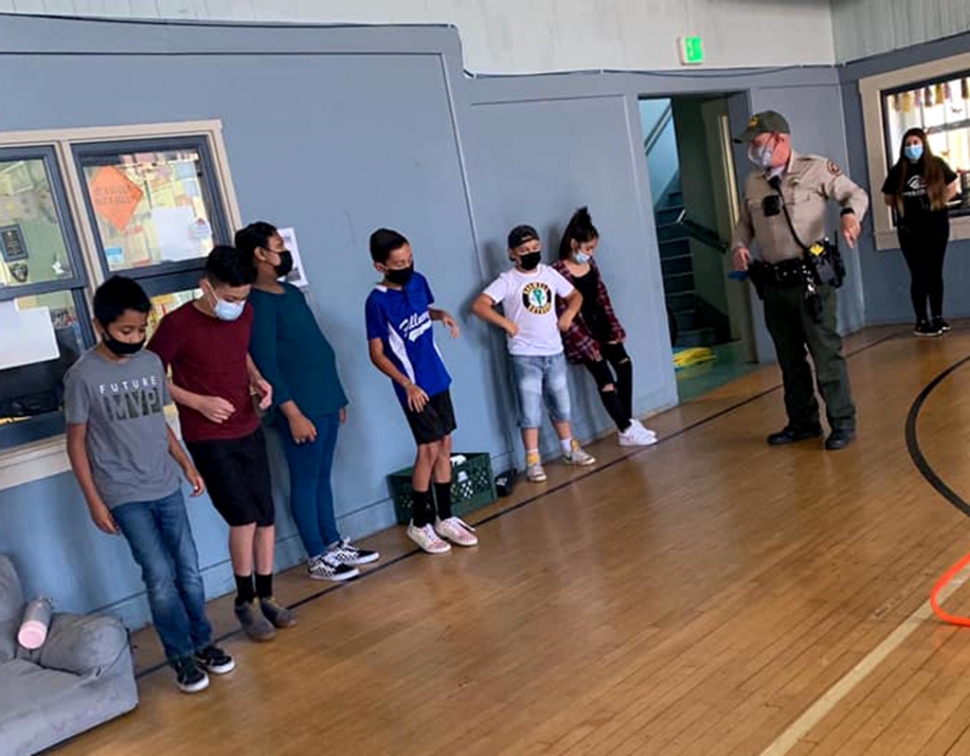 On Friday afternoon, June 25th, School Resource Officer Jonathan Schnereger made a stop at the Fillmore Boys & Girls Club of SCV to help out with the Fun Friday Relay Race. Kids line up as he explained the racing events. Courtesy Boys & Girls Club of Santa Clara Valley.