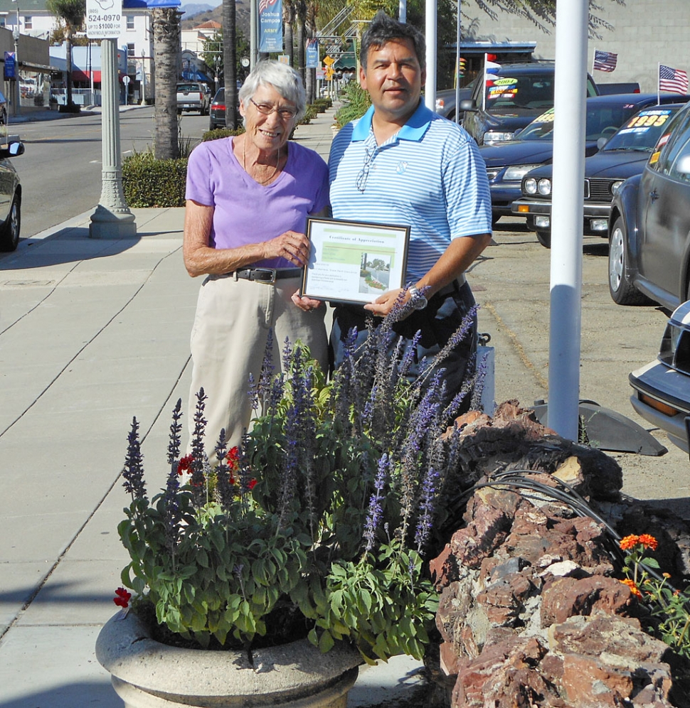 (l-r) Sarah Hansen, Civic Pride member, presenting Bill Herrera with a certificate of appreciation.