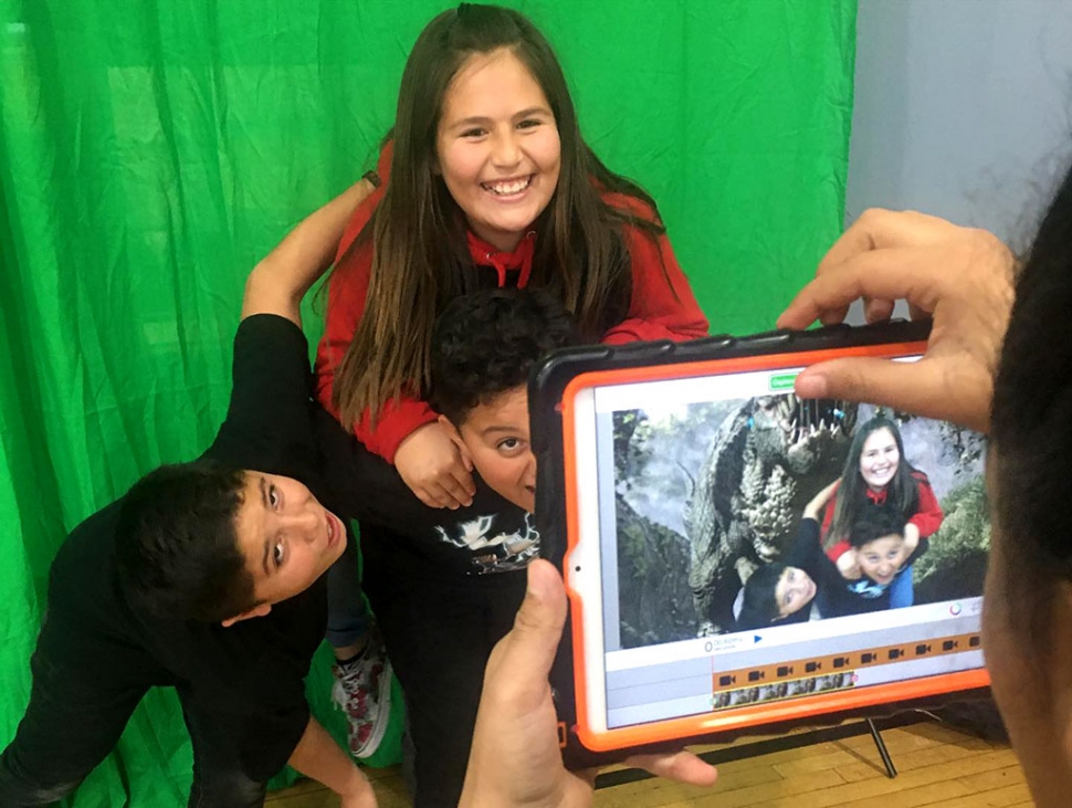 Thursday, December 19th at Fillmore Boys & Girls Club of Santa Clara Valley, they had fun using a green screen which was brought in for the day as part of a STEM (Science – Technology – Engineering – Mathematics) project. Pictured above and below are some of the kids posing in front of the screen and using the IPad to create different backgrounds and effects on the green screen. Courtesy Boys & Girls Club of Santa Clara Valley Facebook page.
