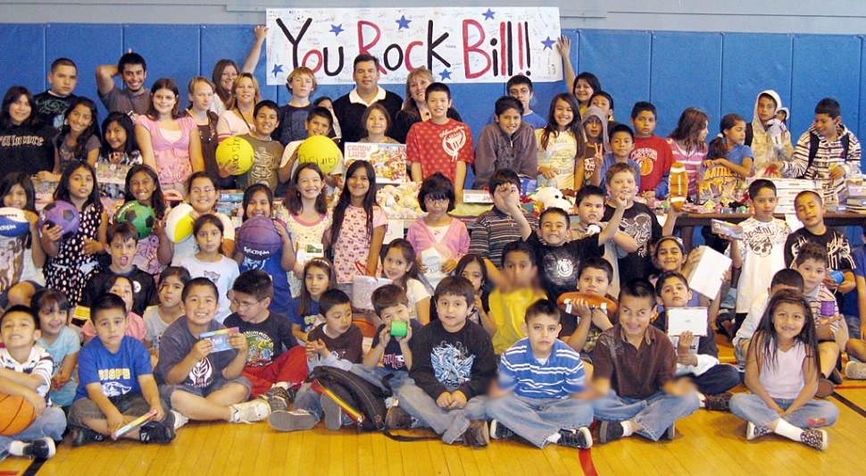Bill Herrera, standing at back, is shown with members of the Fillmore/Piru Boys & Girls Club. Herrera donated
$1,000 to the club. Also shown is his State Farm Insurance office manager Debbie Sanchez.