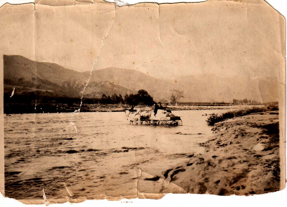 Circa 1905 crossing the river the hard way.