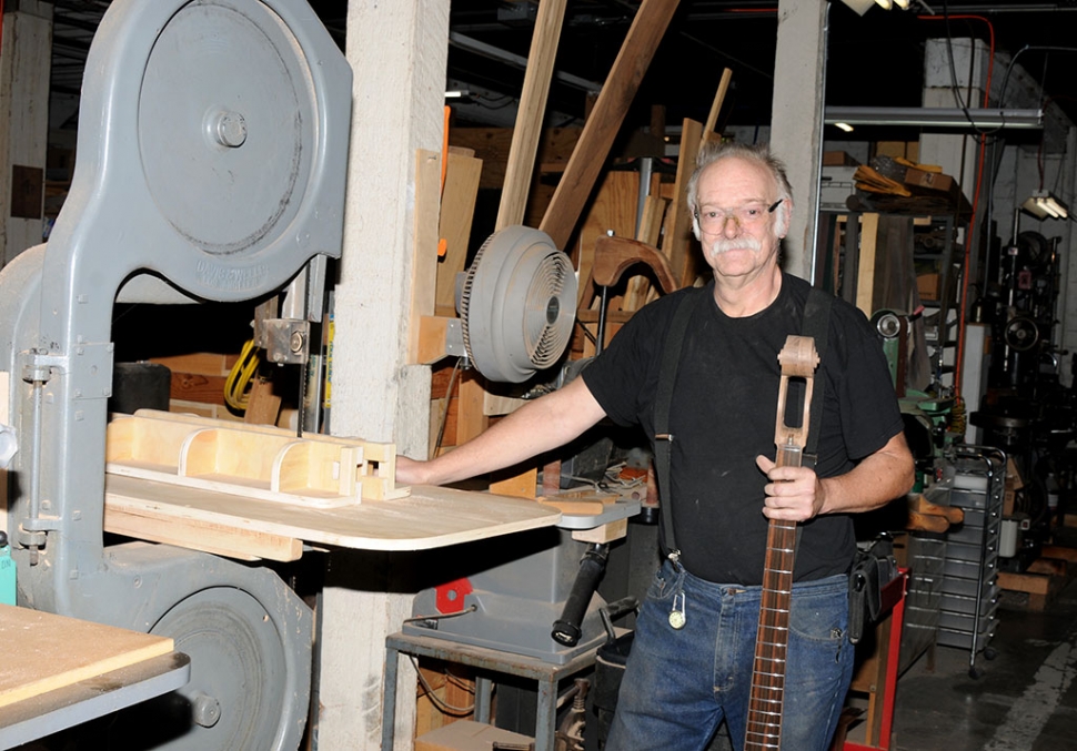 Bruce Johnson in his shop at the Citrus Packing House working on a custom bass guitar.