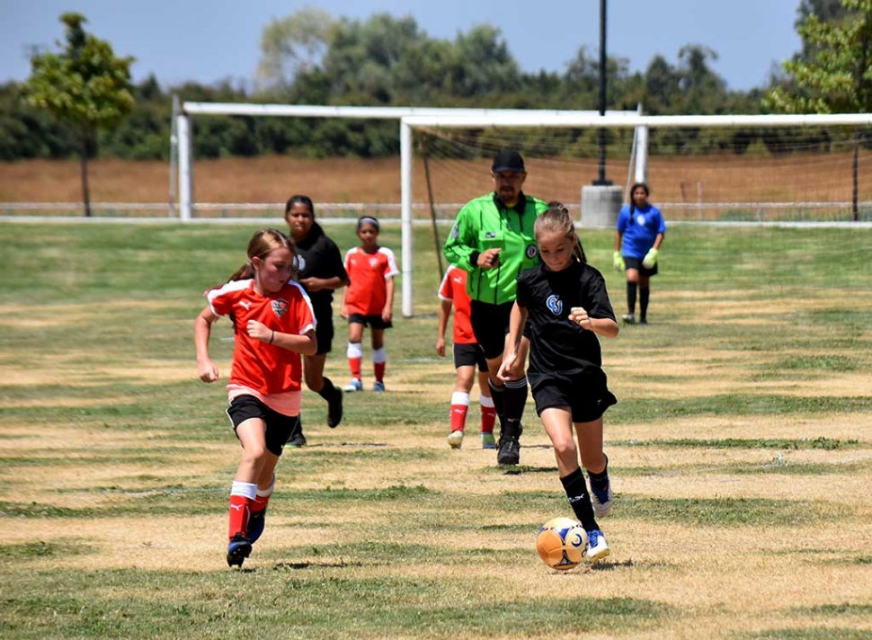 Taking the ball right up the middle, Brooke Nunez runs right by the opponent.