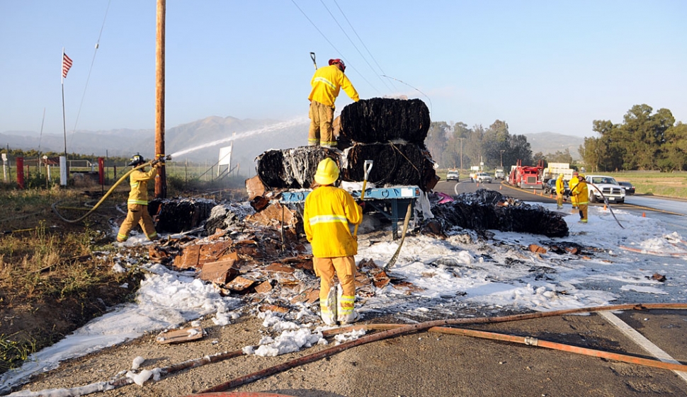 A truck pulling two flatbed trailers loaded with bails of cardboard caught fire near Old Telegraph Road. No damage was caused to the truck, but the cargo was mostly destroyed.