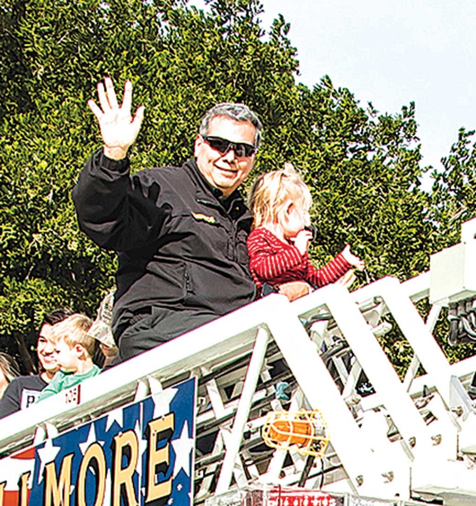 Fillmore Fire Chief Rigo Landeros at the Christmas Parade with grand-daughter Mea.