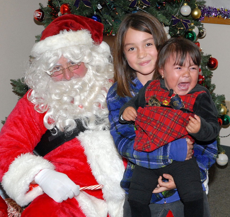 On Tuesday, December 21st, Santa visited the Sheriff’s Storefront for their Annual Christmas Toy Giveaway. Each child received a candy cane and a Polaroid picture on Santa’s lap. Some were happier than others to have their picture taken with Santa, as we can see. Each child also received a Christmas gift and jacket. Approximately 150 turkeys were also given away to local families, along with fresh vegetables. And Sespe 4-H handed out socks.