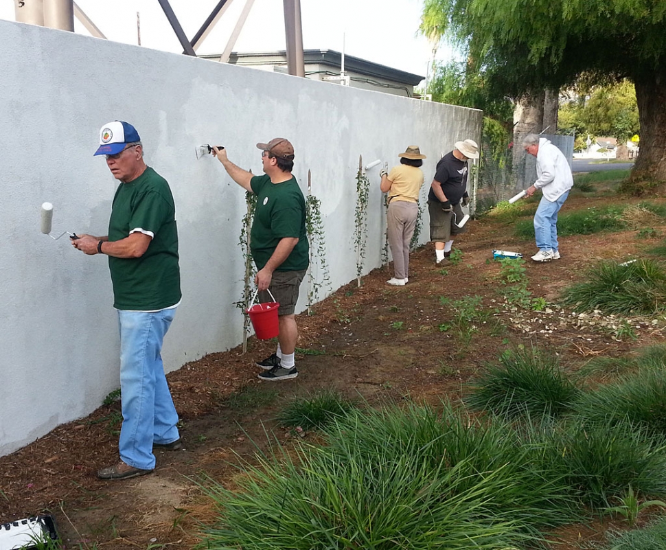 Dorsey Smith, council candidate Douglas Tucker and several other volunteers painted over graffiti last Saturday near the Verizon tower on A Street. 