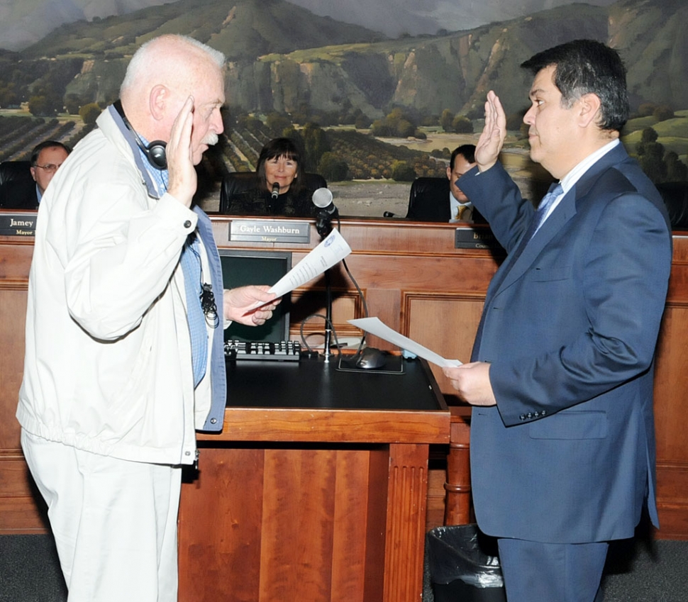 City Clerk Clay Westling swears in councilmember Eduardo Gonzalez.