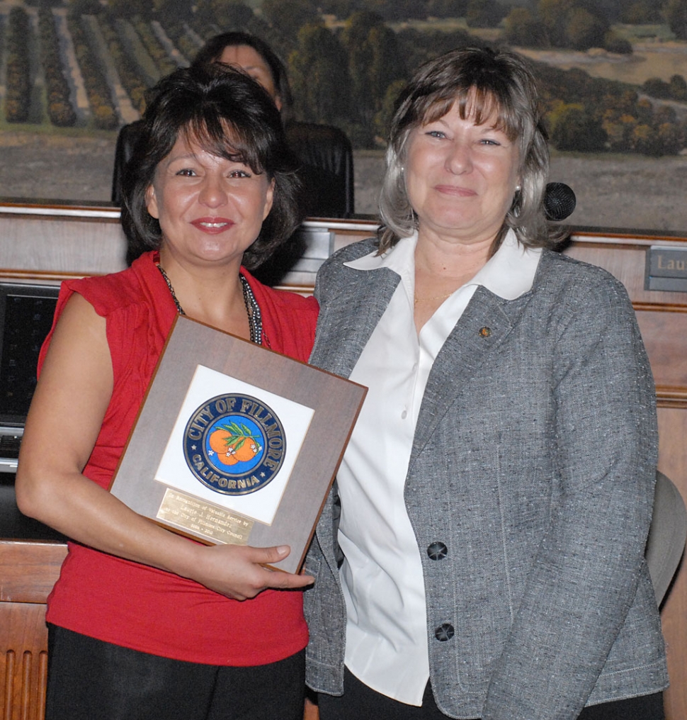 Outgoing councilmember Laurie Hernandez is presented a plaque for her council services from former Mayor Patti Walker.