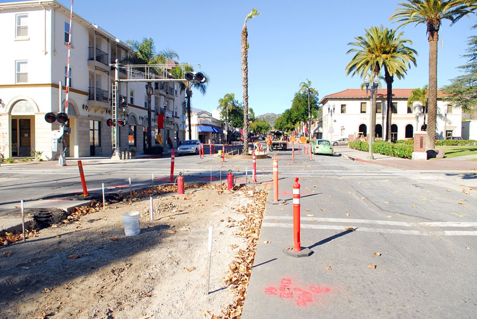 The new city clock will soon be placed on its pedestal at a space a few feet south of the bucket shown in this photo. It is hoped that curbing, power, and the planting of roses will be completed in the next few weeks.