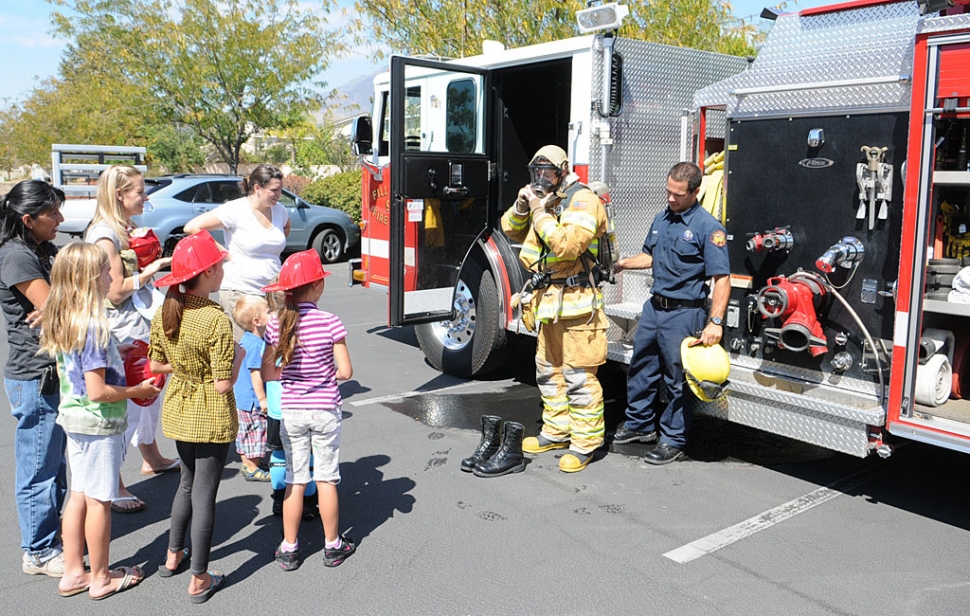 The Fillmore Fire Department demonstrates the use of fire gear to an interested audience.
