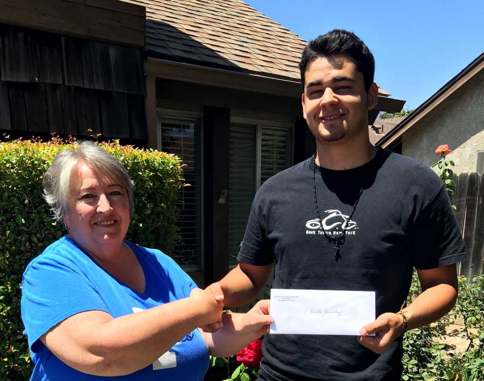 Emilio Hernandez, Class of 2015 receives his continuing education grant from Vice President of the Fillmore High Alumni Association, Corinna 