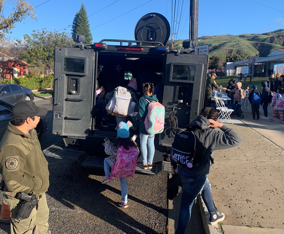 Fillmore School Resource Officers coordinated with the Fillmore Unified School District and the Fillmore Police Station to put on a Donut with a Cop event at San Cayetano Elementary on Tuesday, February 28. Deputies from the Fillmore Station, Explorers, SWAT operators and the Bearcat (armored rescue vehicle) met students as they came to school in the morning. Fillmore station staff shared donuts with the students and coffee with the parents as everyone met their local deputies and explored the Bearcat. A special thanks to Angel’s Donuts for their contribution to the event. This was a great event to establish positive contacts between law enforcement and Fillmore youth. The Fillmore Station is dedicated to building lasting relationships with the Fillmore community through events like Donut with a Cop.