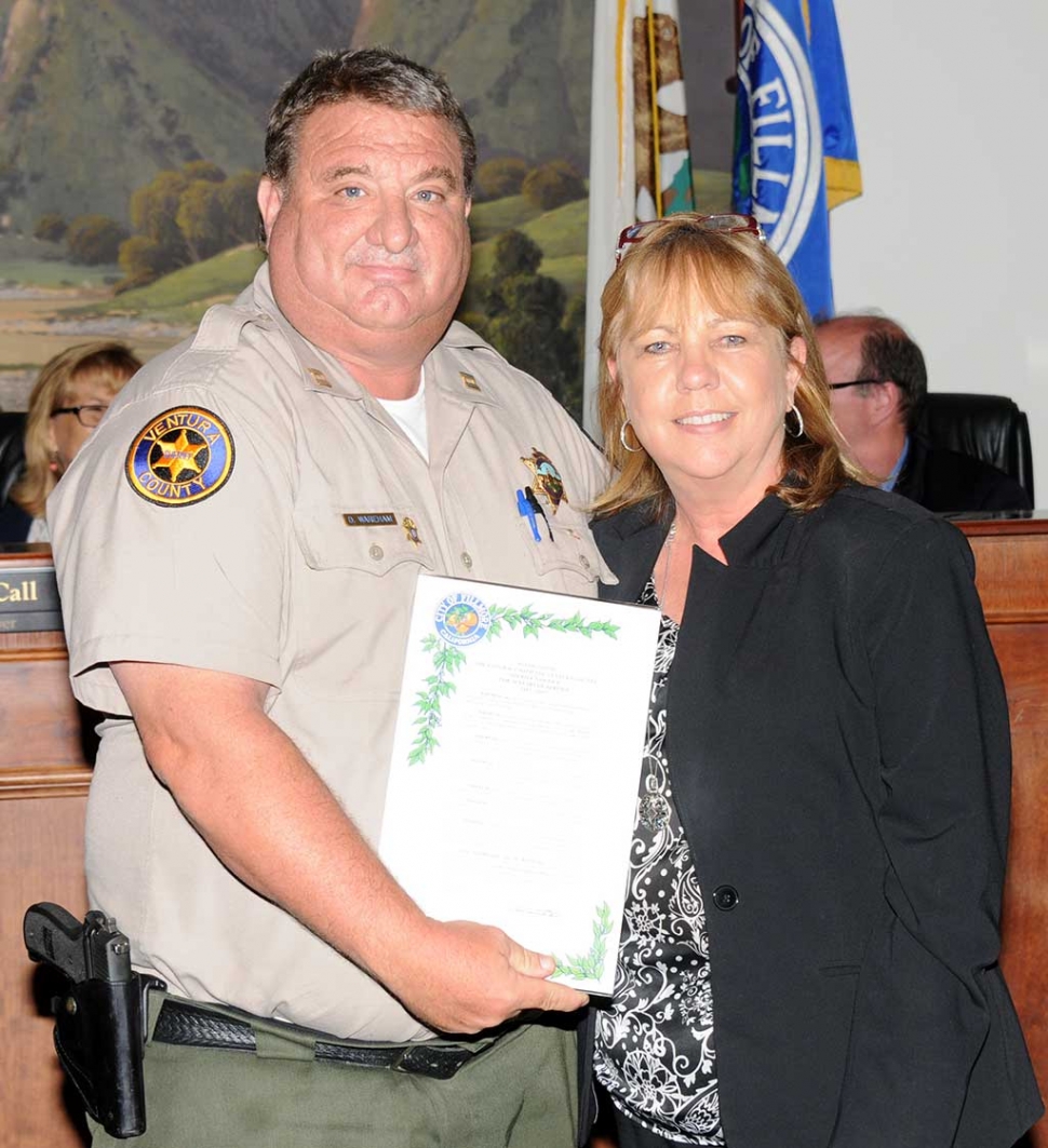 At Tuesday night’s Fillmore City Council meeting (above) Police Chief Dave Wareham accepted a plaque from Mayor Carrie Broggie recognizing the Fillmore/Ventura County Police Department for their 30 years of service to the Fillmore community. 