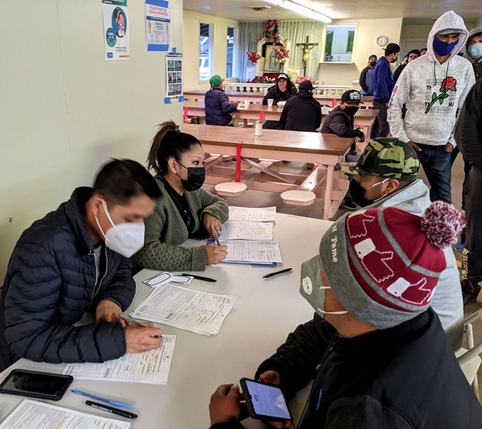 Volunteers helping farmworkers register to get their COVID-19 vaccines.