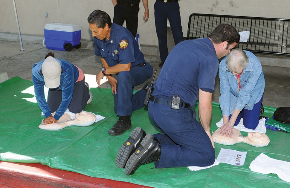 Outside of Vons Supermarket Captain Al Huerta, along with a team member, shows citizens how to perform the new “Hands-Only” CPR.