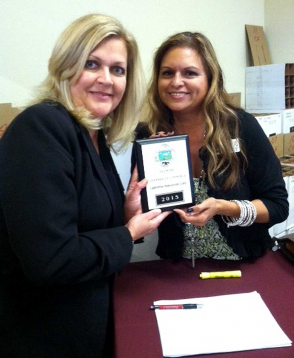 Fillmore Chamber board member Ari Larson presents a membership plaque to Amy Fonzo from California Resources Corp. CRC is the largest oil and natural gas producer in California on a gross-operated basis. CRC is proud to support the Fillmore community where it operates and producing “Energy for California by Californians.”