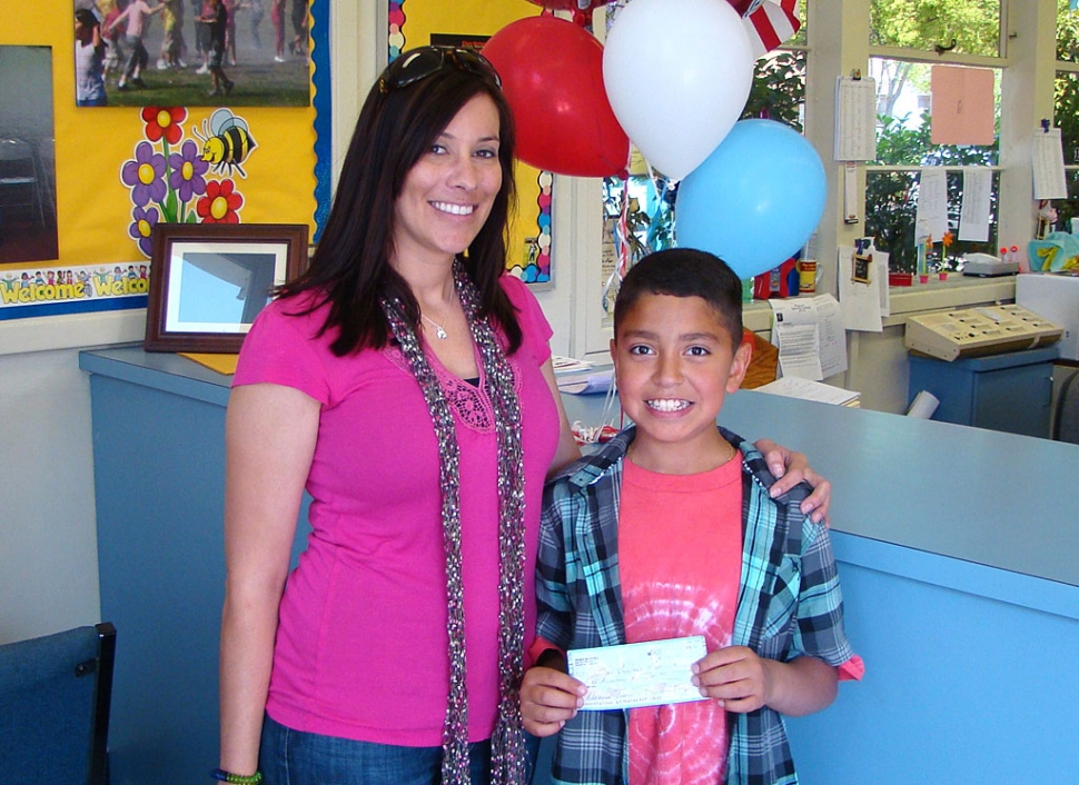 5th grader Alex Turcios is shown with Mrs. Chisholm, 4th/5th grade NASA teacher at San Cayetano . Alex, on behalf of his parents, Renee and Felipe Perez, presents Mrs. Chisholm with a donation check for $500 for the San Cayetano NASA Program. Alex has been involved in both the Robotics and Micro-Gravity Science and his parents feel that he has come away with a new and exciting interest in math and science.