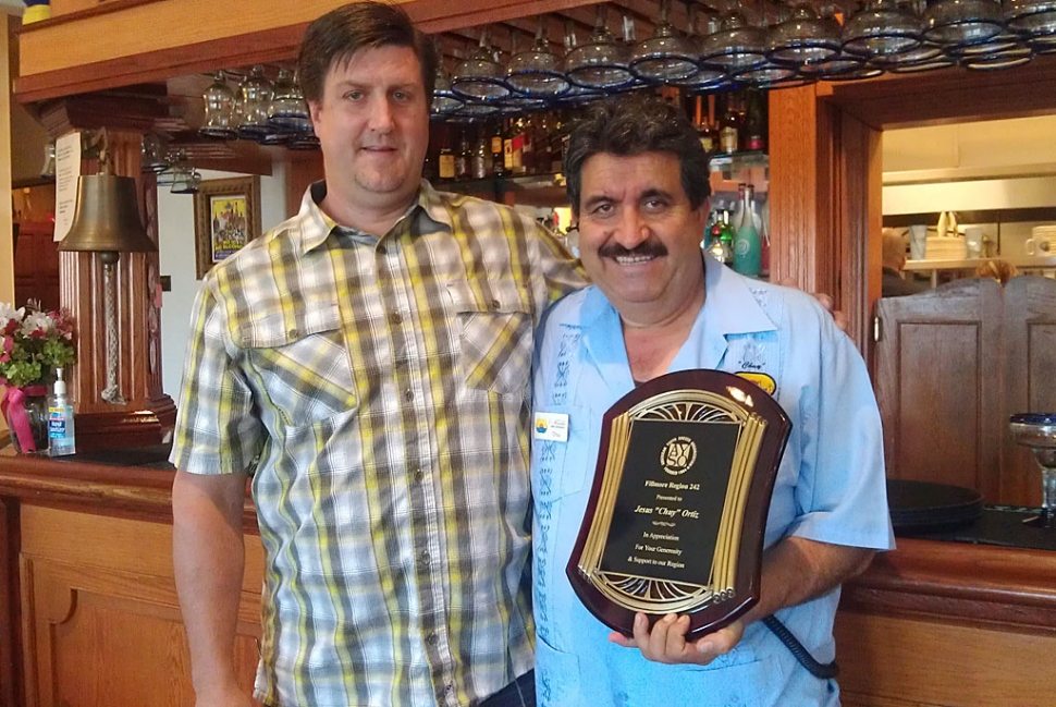 (l-r) Darren Rosten, Region 242 Commissioner, presented this plaque to show his appreciation to Chuy Ortiz, owner of El Pescador, for the support he has given to the local youth soccer organization, AYSO, Region 242. We look forward to his continued support.