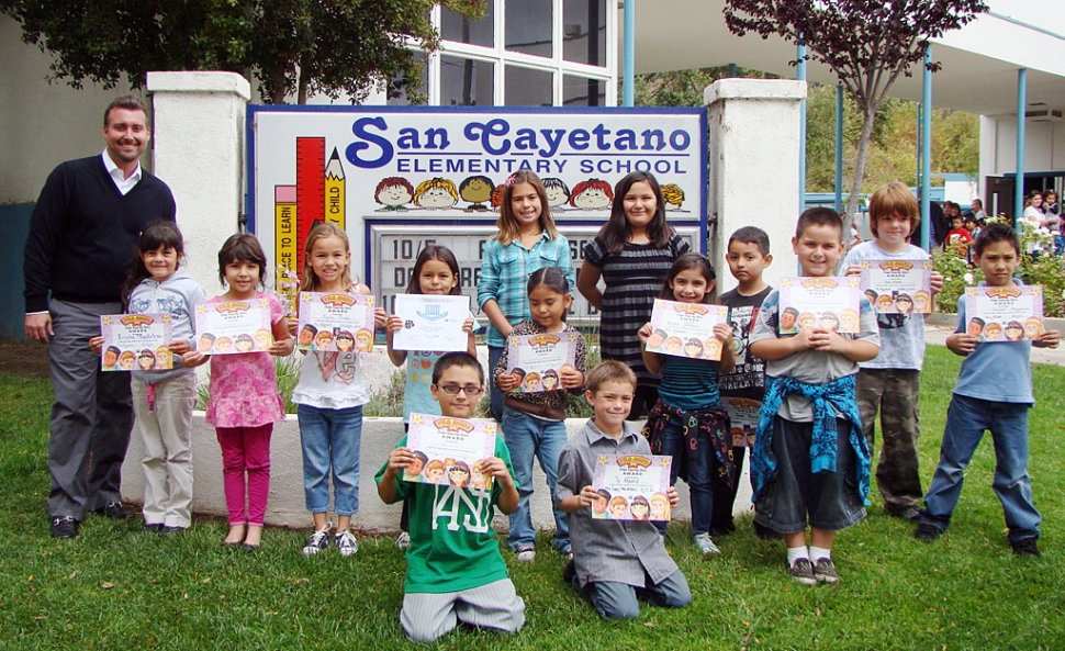 Paul Capra of John Paul Pet is pictured with student Peacebuilder winners for October.