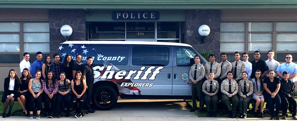 Explorers pose with their new van which was purchased to help transport the young men and women, 14 to 21, who have an interest in learning more about a career in Law Enforcement, to community events, meetings, and training events, both within the county and out of state.
