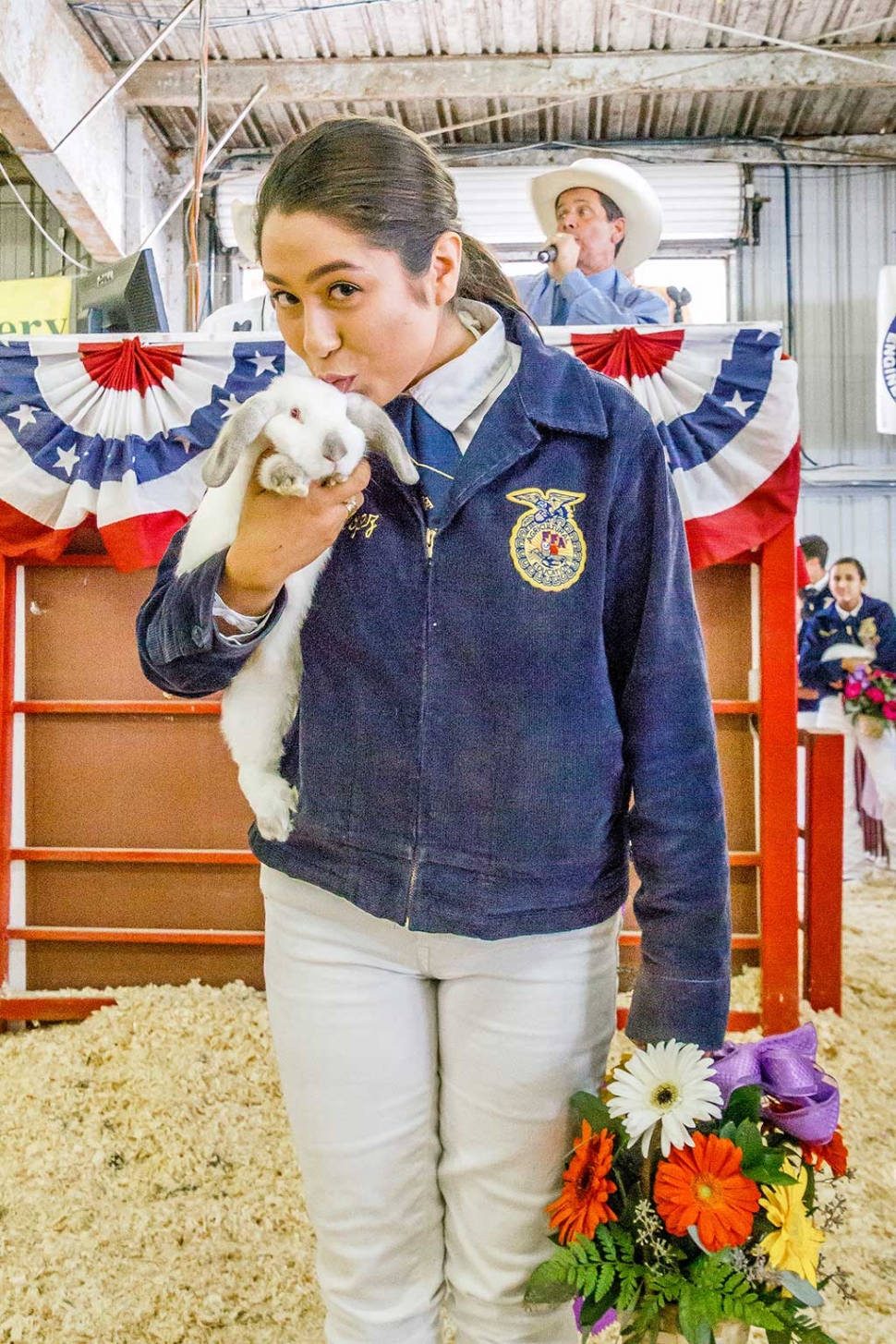 Carolina Lopez of Fillmore FFA, pictured with one of her three Grand Champion Market Rabbits, high bidder paid $1,100 for all three rabbits. 