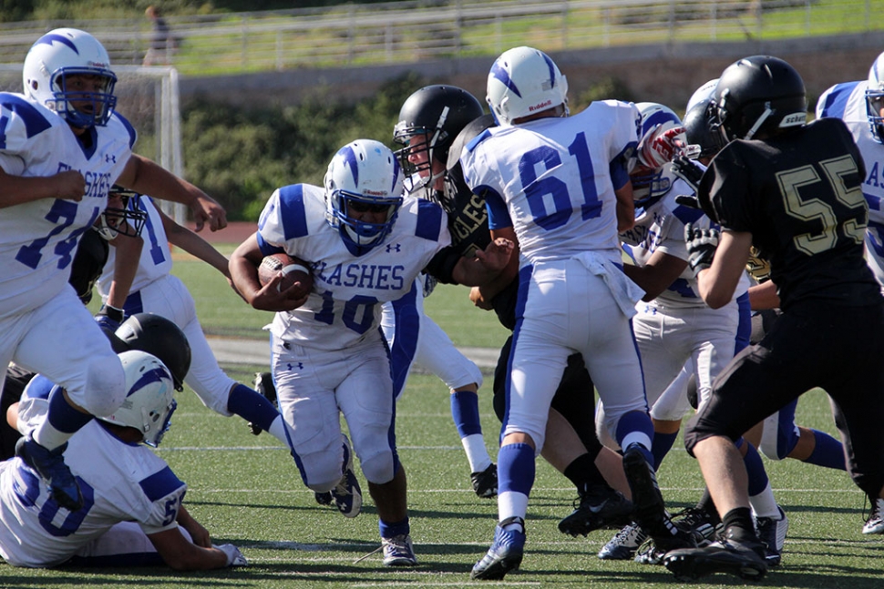 Daniel Tafoya rushes for a first down as 61 Cody Isaacs and 74 Brandon Castillo Lead the way.