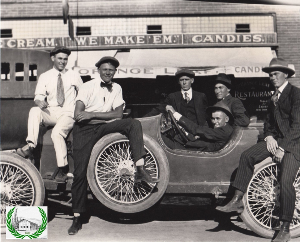 Men in front of Mack Wooldridge's Orange Leaf Café. 