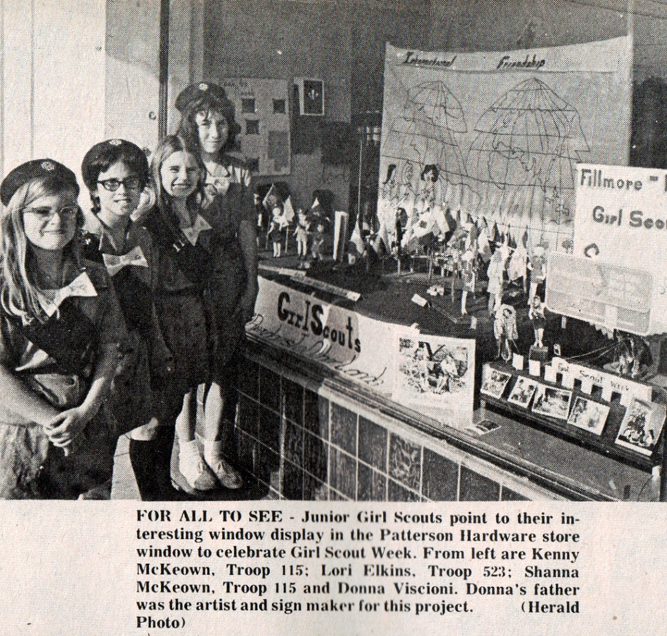 Article from the Fillmore Herald March 16th 1972 reading “The Junior Girl Scouts point to their interesting window display in the Patterson Hardware store window to celebrate Girl Scout Week. From left are Shanna KcKeown, Troop 115; Lori Elkins, Troop 523; Shanna KcKeown, Troop 115 and Donna Viscioni. Donna’s father was the artist and sign maker for this project. (Herald Photo).
