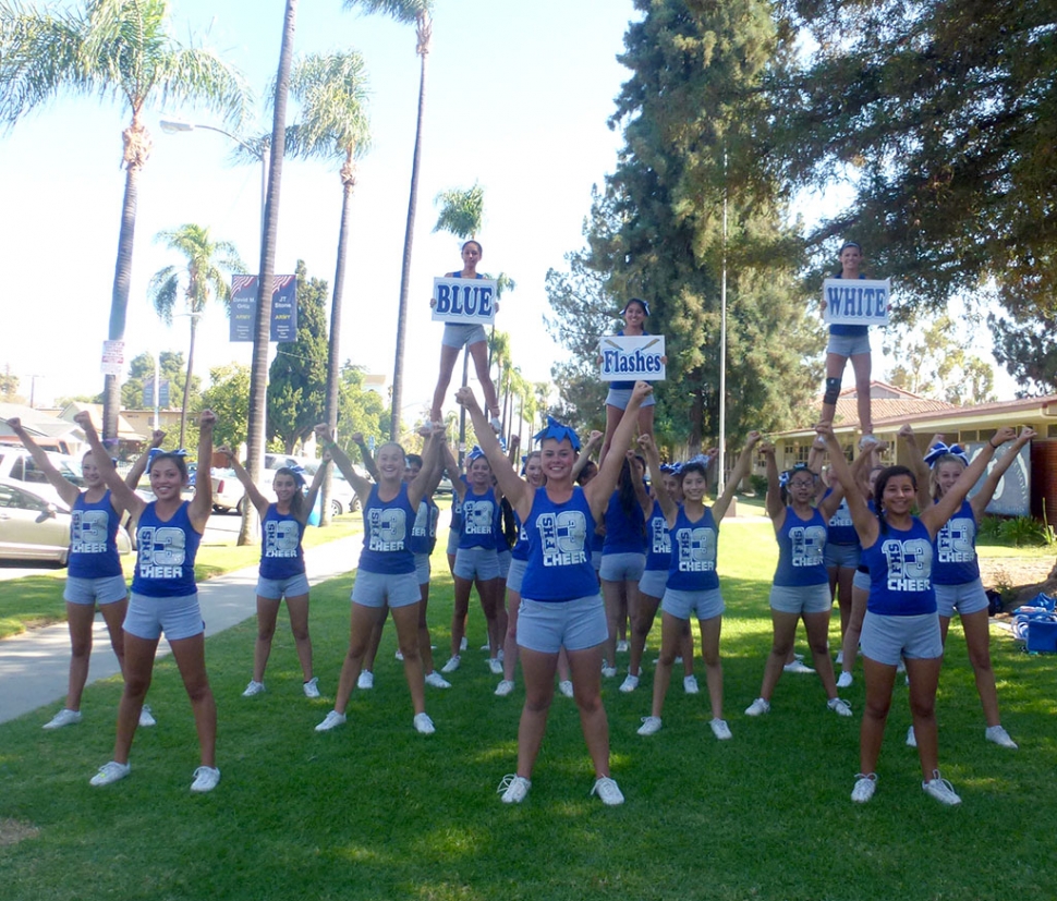 BLUE - FLASHES - WHITE. The Fillmore Flashes Cheerleaders do their thing for the camera. The girls practice in front of the high school building after school.