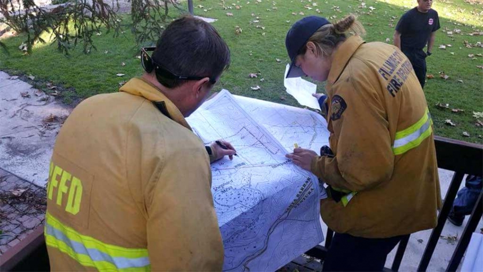 Fillmore Fire Fighters looking over a map of the Montecito Mudslide area, where they were assisting with search and rescue/recovery mode last week.