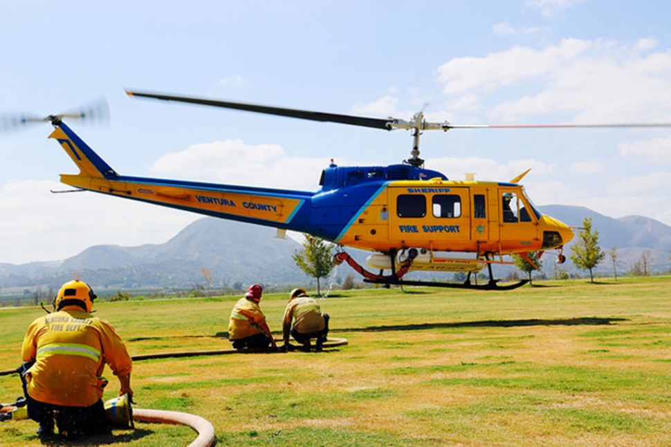 You may have heard them all day last Thursday, helicopters flying over Fillmore from sun-up to sun-down. All available Ventura County helicopters were used to drop water on the “Burson Fire” this week, refilling water at Two Rivers Park in Fillmore. Private helicopters were contracted due to a shortage of County helicopters which are being used in other California fires up north. As of Tuesday, the wildfire burning above Fillmore in the Sespe Mountain range was over 90% contained. Approximately 30 acres were burned in the “Burson Fire”, which was reported last Wednesday night on the Burson Ranch, along the southern edge of the Los Padres National Forest near Hopper Mountain. A large amount of equipment from Cal Fire, the US Forest Service and Ventura County was utilized in fighting the fire. No structures were threatened, and no injuries were reported. The Cornell Lab Condor Cam was shut down for a few days to protect the equipment; the Condors were never in any danger. The cause of the fire is under investigation. One theory was the underground geothermal activity in the area that has started vegetation fires in the past. Photo courtesy Sebastian Ramirez.