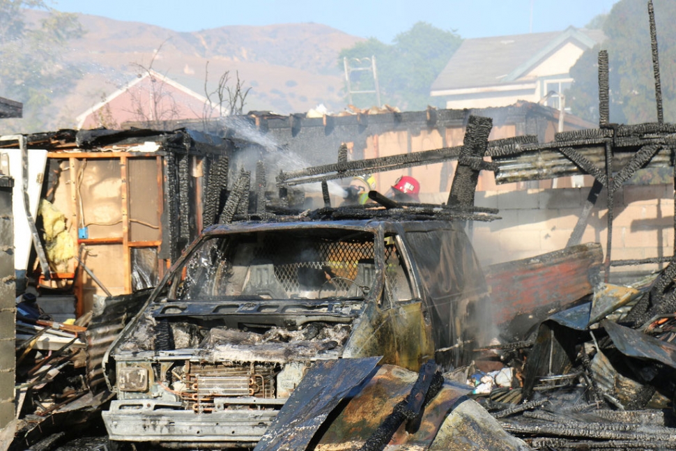 On Sunday, October 19, at approximately 4:08pm, Fillmore Fire Department responded to a reported structure fire on the 800 block of Blaine Street. Upon arrival Fillmore Chief 1 reported that he was on scene of a detached garage heavily involved in flames with exposures to two adjacent structures. Due to the quick work by Fillmore fire, County fire and Santa Paula fire Departments, fire personnel were able to save the two adjacent structures that only sustained minimal damage. The detached garage was a total loss and the cause of the fire is under investigation. No injuries to report. Photos by Sebastian Ramirez.