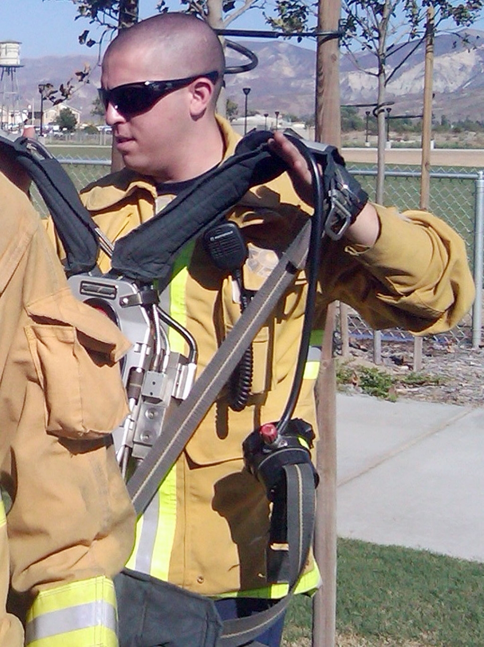Robert Katz of Ventura assists with the breathing apparatus in Operation: Deck the N00b, a timed team exercise. Photo Credit: Bill Herrera, Fillmore Fire Department.