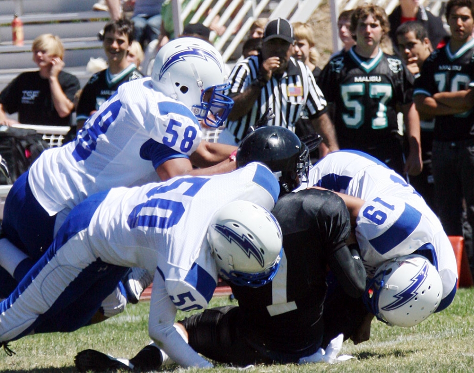 Above Johnny Wilber #50, Derek Luna #58, and Daniel Cruz #19 were tough on defense.